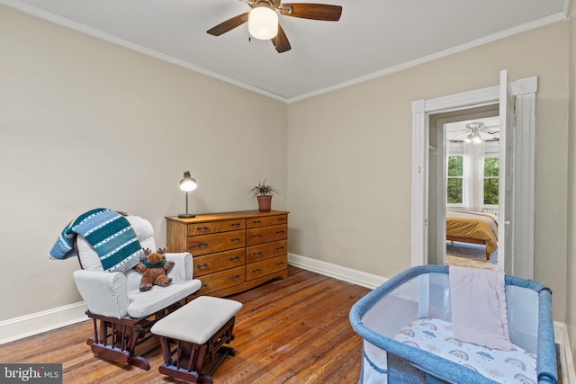 sitting room featuring baseboards, ornamental molding, hardwood / wood-style floors, and ceiling fan