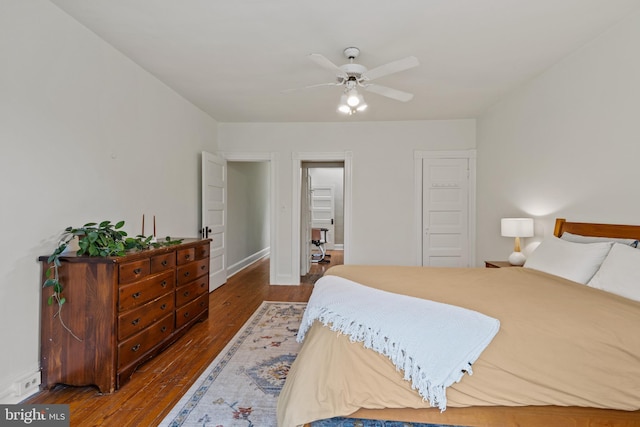 bedroom with dark wood-type flooring, ceiling fan, and baseboards
