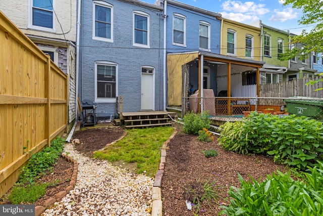 rear view of house featuring fence, entry steps, and a residential view