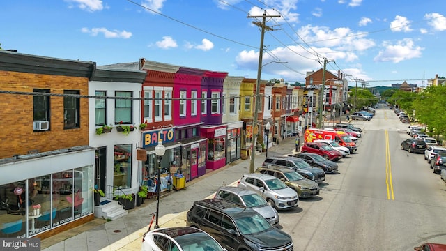 view of asphalt street with street lights, sidewalks, and curbs