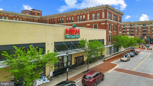 view of building exterior featuring uncovered parking