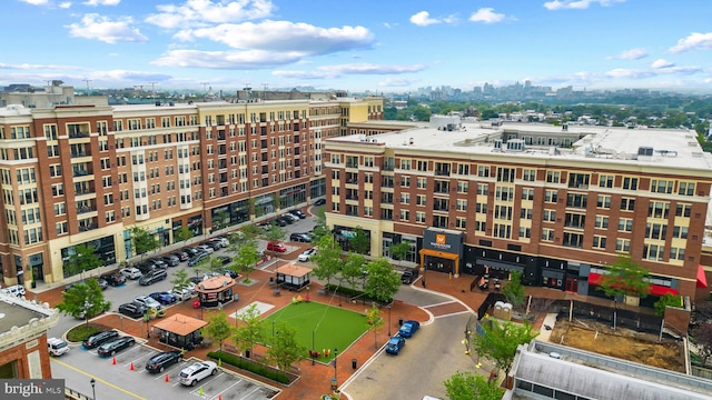 view of property with a view of city and uncovered parking