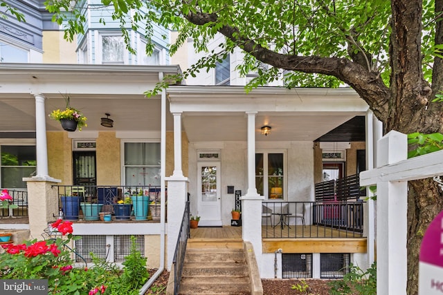 view of front facade with a porch and stucco siding