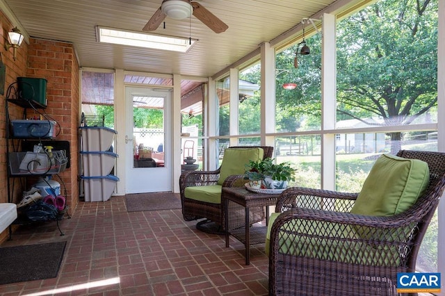 sunroom with ceiling fan and a skylight