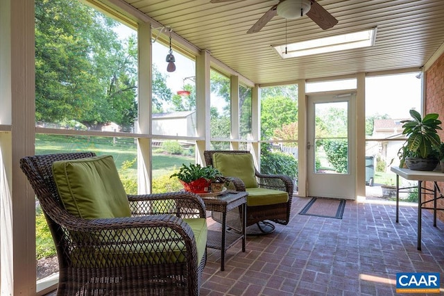 sunroom / solarium featuring a ceiling fan and healthy amount of natural light