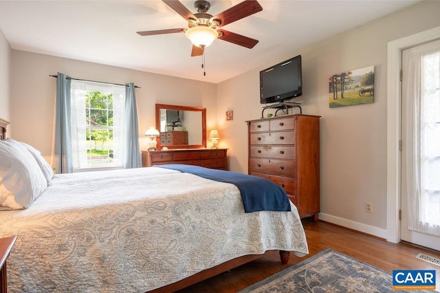 bedroom with wood finished floors, baseboards, and a ceiling fan