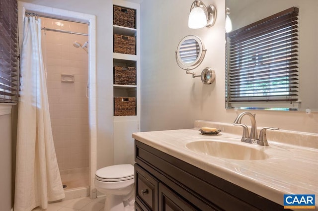 full bath with a stall shower, toilet, tile patterned floors, and vanity