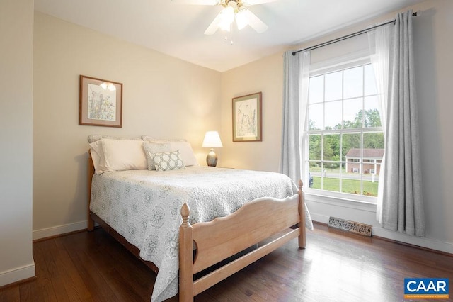 bedroom with baseboards, wood finished floors, and a ceiling fan