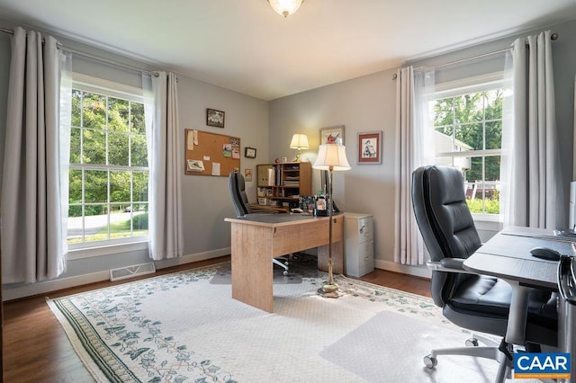 office area with plenty of natural light, baseboards, and wood finished floors