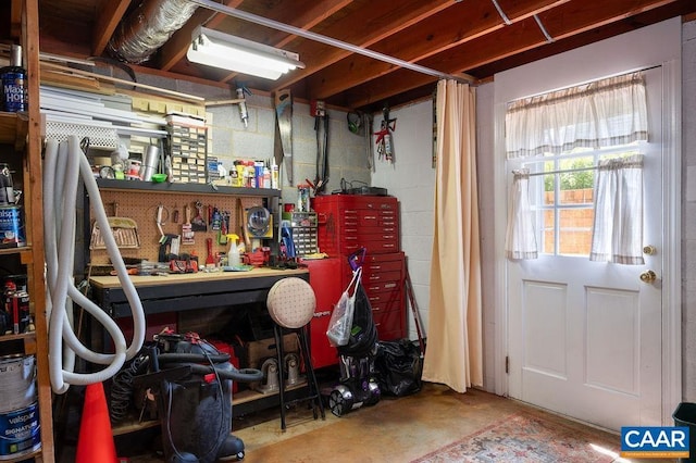 below grade area featuring a workshop area and concrete block wall