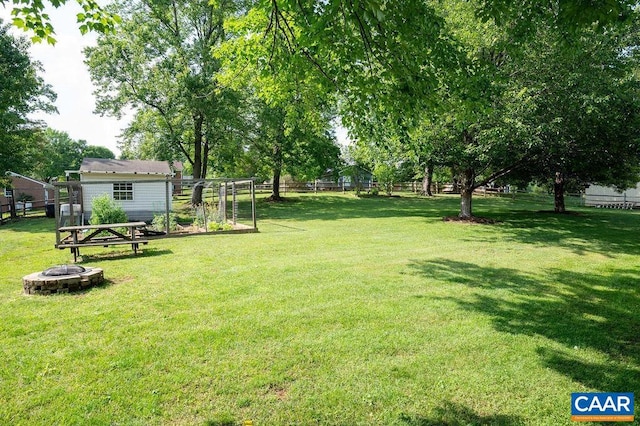 view of yard featuring an outdoor fire pit