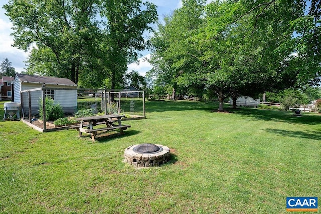 view of yard with an outdoor fire pit