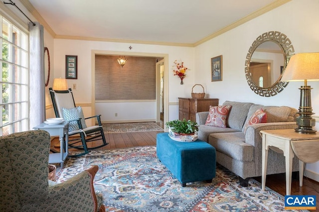 living room featuring hardwood / wood-style flooring, crown molding, and baseboards