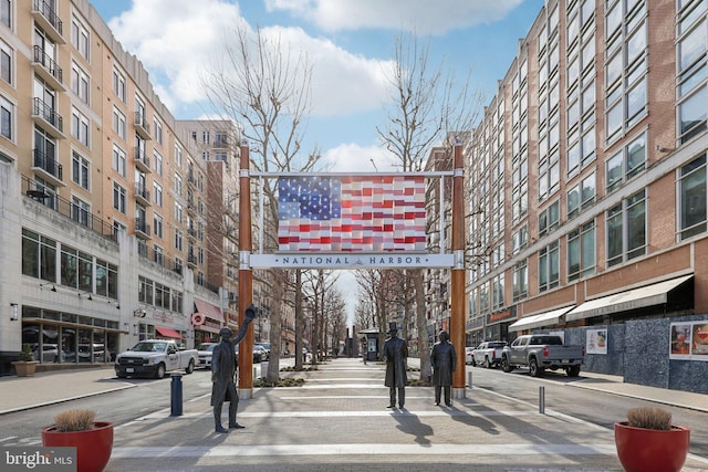 view of asphalt road featuring sidewalks, street lighting, and curbs