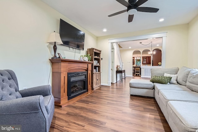 5622 Pilgrim Rd, Baltimore, MD 21214 - living area with a glass covered fireplace, wood finished floors, ceiling fan, recessed lighting, and a chandelier