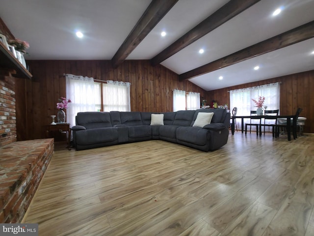 living area with wood walls and light wood finished floors