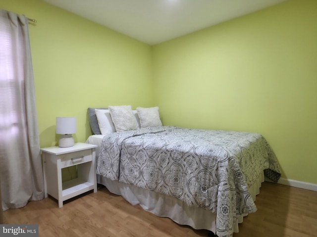 bedroom with wood finished floors and baseboards