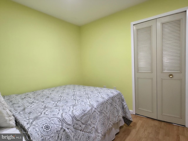 bedroom featuring wood finished floors and a closet