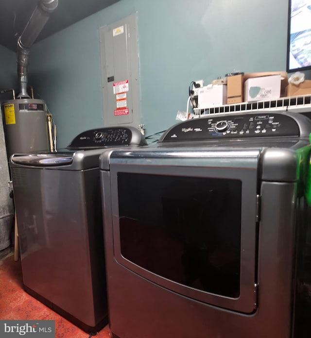 washroom with washing machine and clothes dryer and electric panel