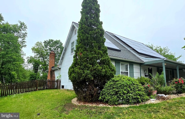view of side of property with a shingled roof