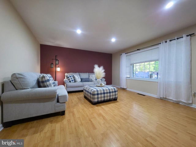 living area with wood finished floors, recessed lighting, and baseboards