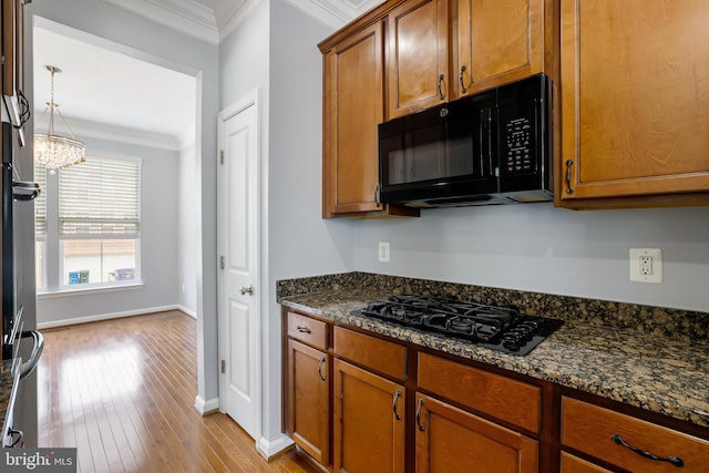 23462 Twin Falls Ter, Ashburn, VA 20148 - kitchen with black appliances, crown molding, brown cabinets, wood finished floors, and dark stone countertops