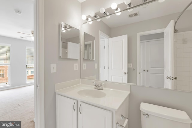 23462 Twin Falls Ter, Ashburn, VA 20148 - bathroom with toilet, vanity, ceiling fan, and a shower