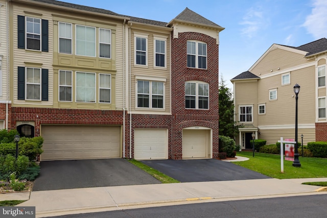 23462 Twin Falls Ter, Ashburn, VA 20148 - townhome / multi-family property featuring driveway, brick siding, and an attached garage