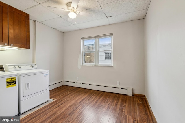 laundry area featuring washer and clothes dryer, a baseboard radiator, cabinet space, wood finished floors, and ceiling fan