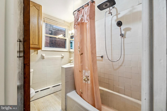 bathroom with a baseboard radiator, toilet, tile walls, shower / tub combo with curtain, and wood finished floors
