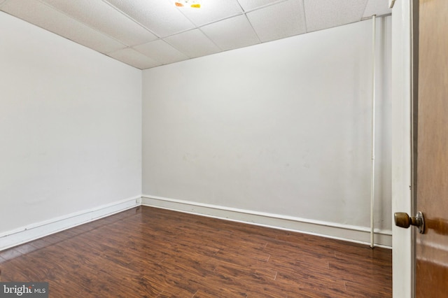 spare room with dark wood finished floors and baseboards