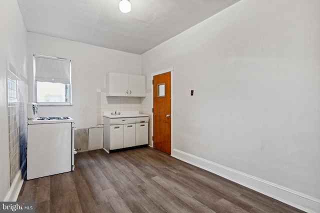 kitchen with range, dark wood-type flooring, white cabinets, and light countertops