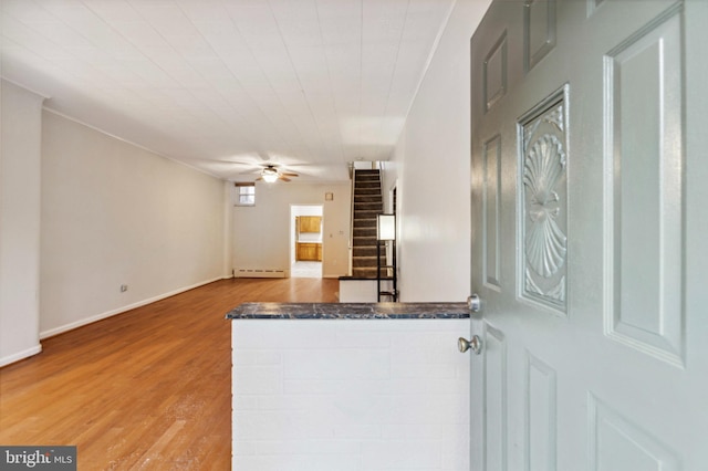 entrance foyer featuring stairs, a ceiling fan, wood finished floors, and baseboards
