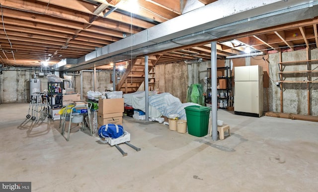 2 W Cartwright Dr, Princeton Junction, NJ 08550 - unfinished basement with freestanding refrigerator, water heater, and stairway