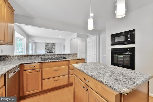 kitchen with black appliances, light wood-style flooring, light stone countertops, a peninsula, and a kitchen island