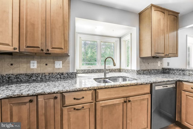 kitchen featuring stainless steel dishwasher, a sink, decorative backsplash, light stone counters, and brown cabinets