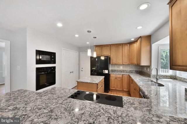 kitchen with black appliances, a sink, light stone counters, recessed lighting, and backsplash