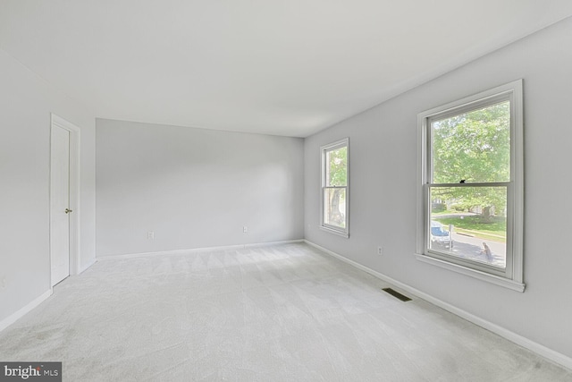 carpeted empty room with baseboards