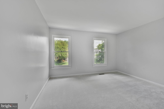 unfurnished room with baseboards and carpet flooring