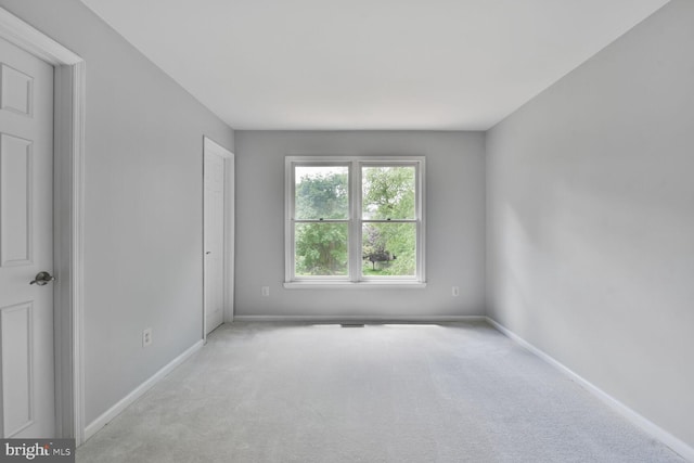 carpeted spare room with baseboards