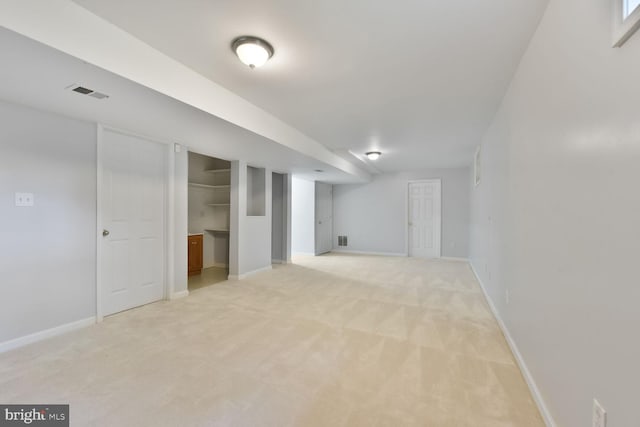 finished basement featuring light carpet and baseboards