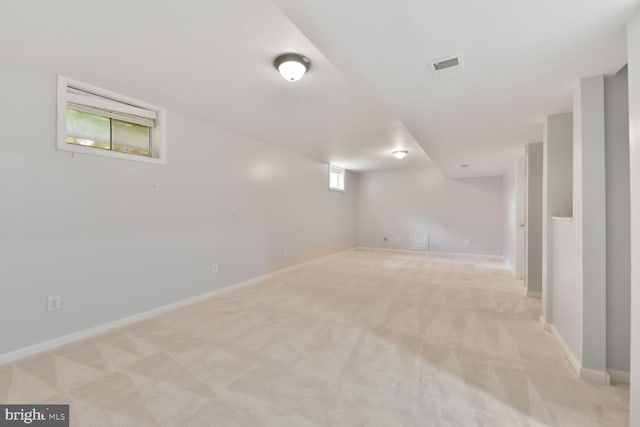 basement with light carpet and baseboards
