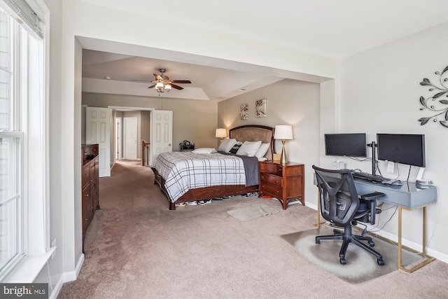carpeted bedroom featuring baseboards and an office area