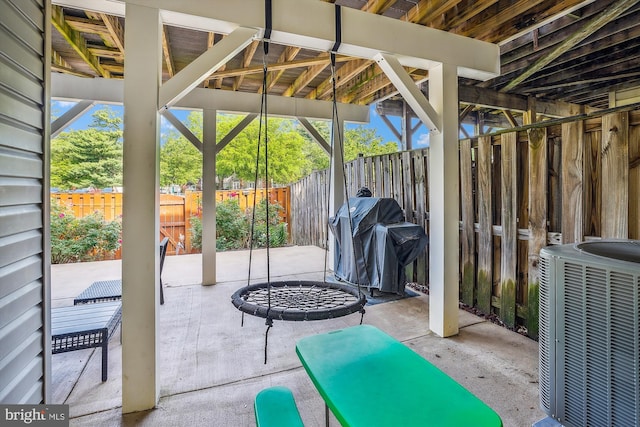 view of patio with central air condition unit, a fenced backyard, and grilling area