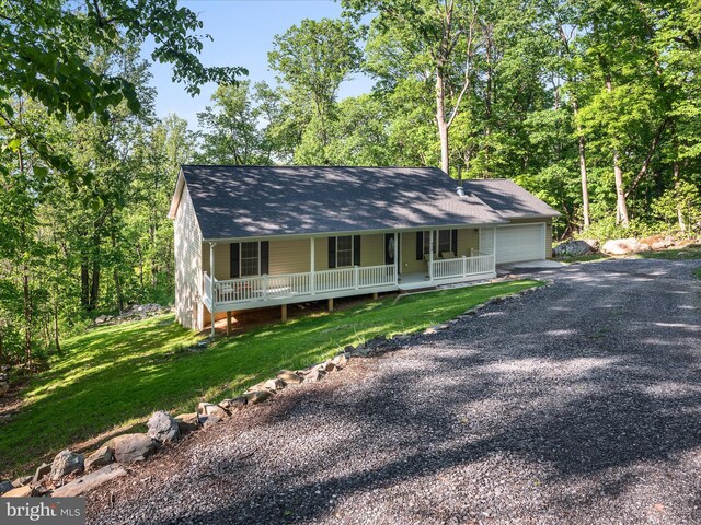 439 Windy Way, Front Royal, VA 22630 - view of front of property with covered porch, gravel driveway, an attached garage, a shingled roof, and a front yard