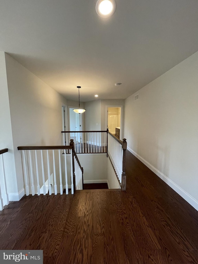 stairs with wood finished floors and baseboards