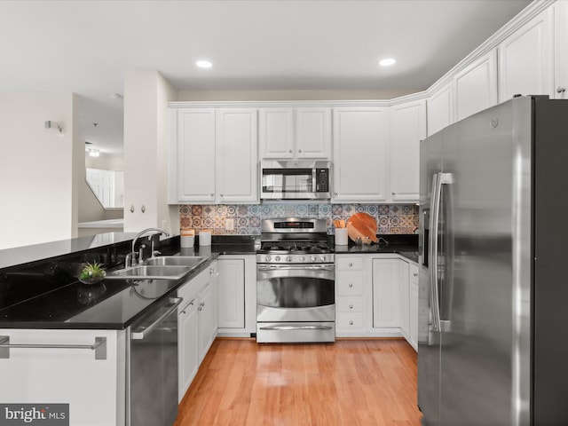 1604 Hunting Creek Dr Unit B, Alexandria, VA 22314 - kitchen featuring stainless steel appliances, a sink, a peninsula, dark countertops, and white cabinetry