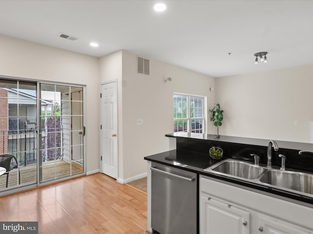 1604 Hunting Creek Dr Unit B, Alexandria, VA 22314 - kitchen featuring dishwasher, a sink, dark countertops, light wood-style flooring, and white cabinetry