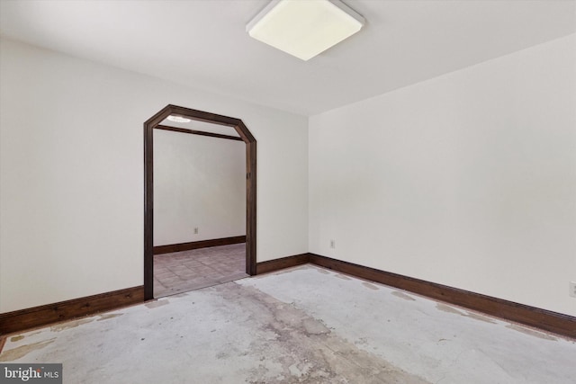 3789 Stump Rd, Doylestown, PA 18902 - spare room featuring unfinished concrete floors, arched walkways, and baseboards