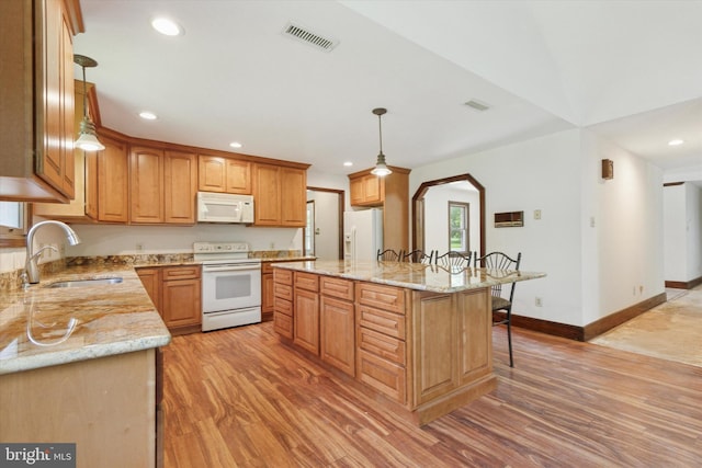 3789 Stump Rd, Doylestown, PA 18902 - kitchen featuring white appliances, a sink, light wood-style flooring, a breakfast bar area, and recessed lighting